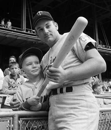 Harmon Killebrew poses with 9-year-old Johnny Guiney at Yankee Stadium on Sept. 12, 1964. Killebrew had visited Johnny in May after he was hospitalized with burns suffered when his altar boy robe caught fire. Johnny asked his idol to hit a homer, and the leading home-run hitter in the major leagues responded with a first-inning, two-run blast. See full story