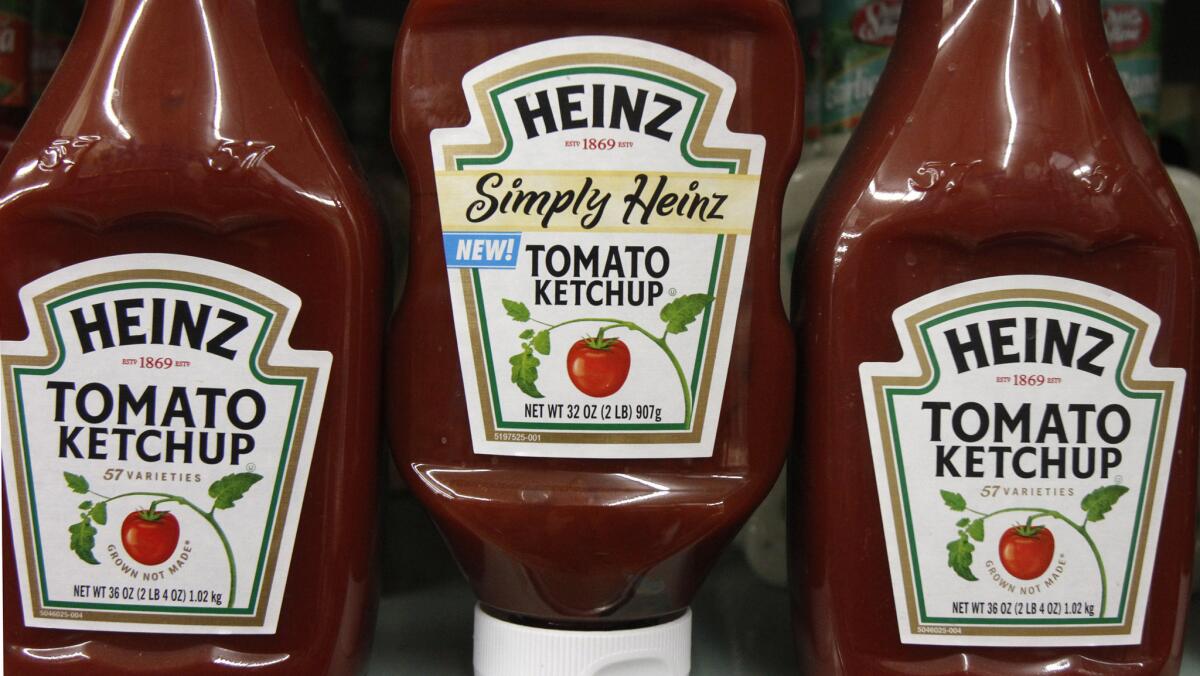 Heinz ketchup bottles are displayed on the shelf of a market. Food giant Kraft Heinz has abandoned its offer to buy Unilever.