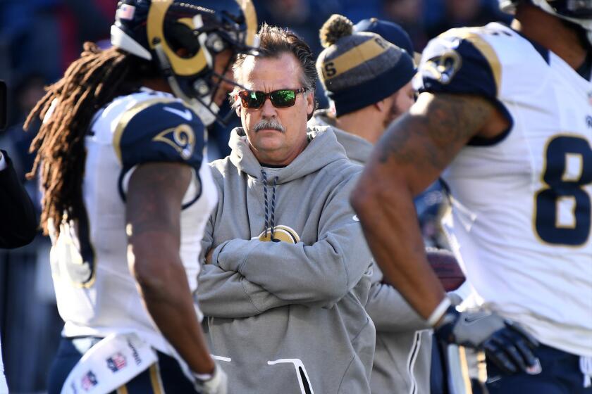 Rams Coach Jeff Fisher watches his players warm up before their game against the Patriots.