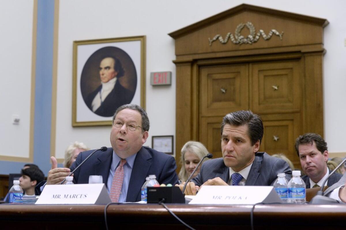 Comcast's David Cohen, left, and Time Warner Cable's Rob Marcus appear before Congress.