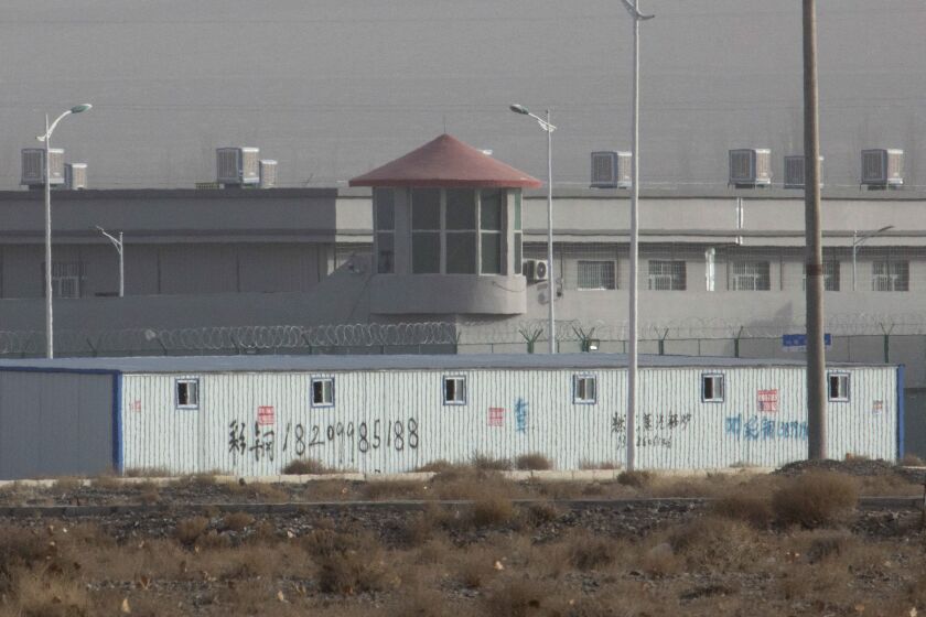 FILE - In this Monday, Dec. 3, 2018, file photo, a guard tower and barbed wire fences are seen around a facility in the Kunshan Industrial Park in Artux in western China's Xinjiang region. An Australian think tank says China appears to be expanding its network of secret detention centers in Xinjiang, where Muslim minorities are targeted in a forced assimilation campaign. (AP Photo/Ng Han Guan, File)