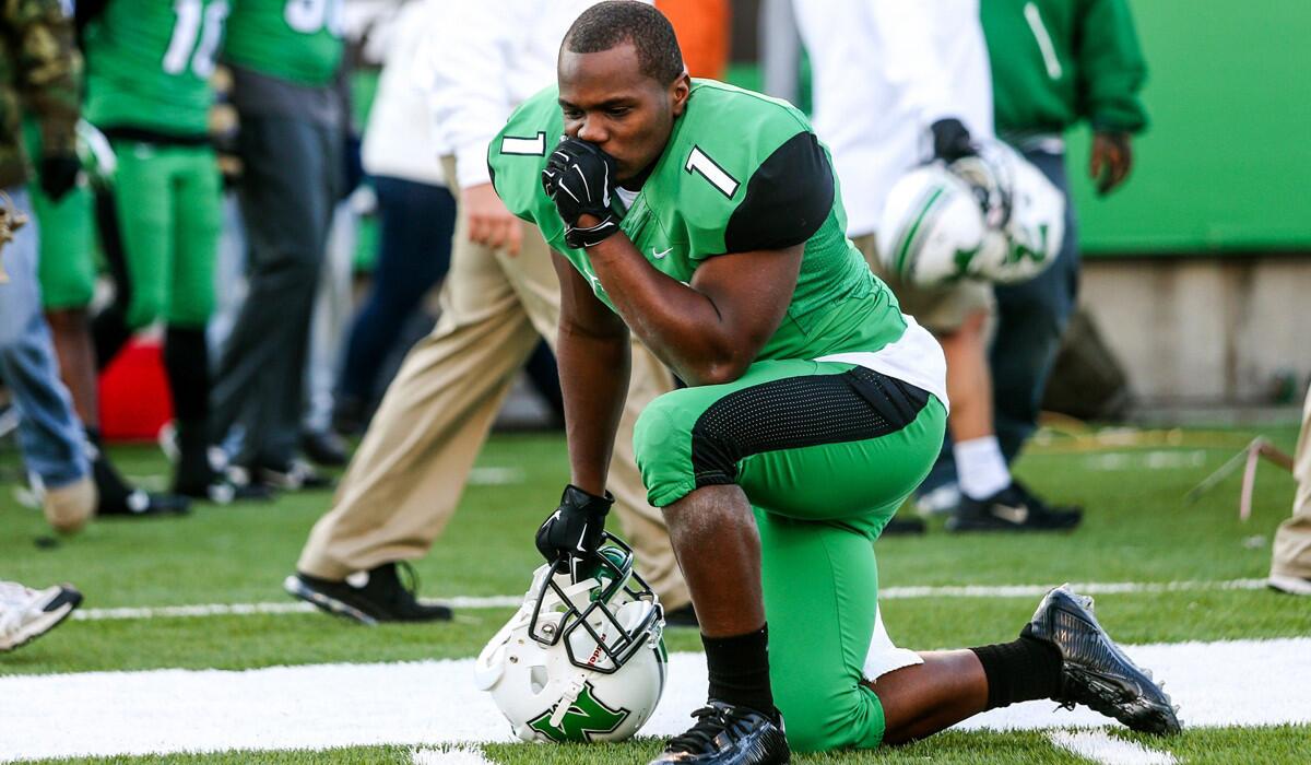 Marshall wide receiver Tommy Shuler falls to one knee after the Thundering Herd lost their first game of the season, a 67-66 overtime thriller against Western Kentucky on Friday.