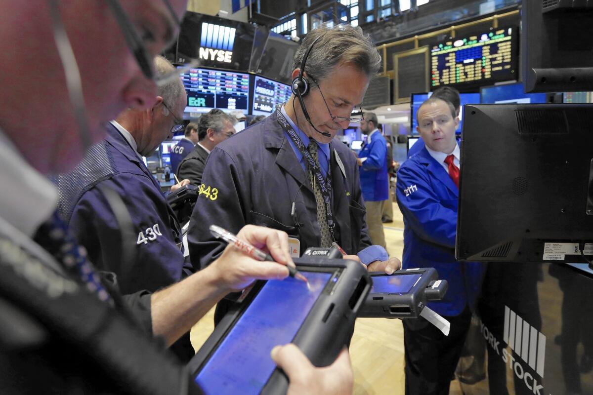 Traders gather on the floor of the New York Stock Exchange.