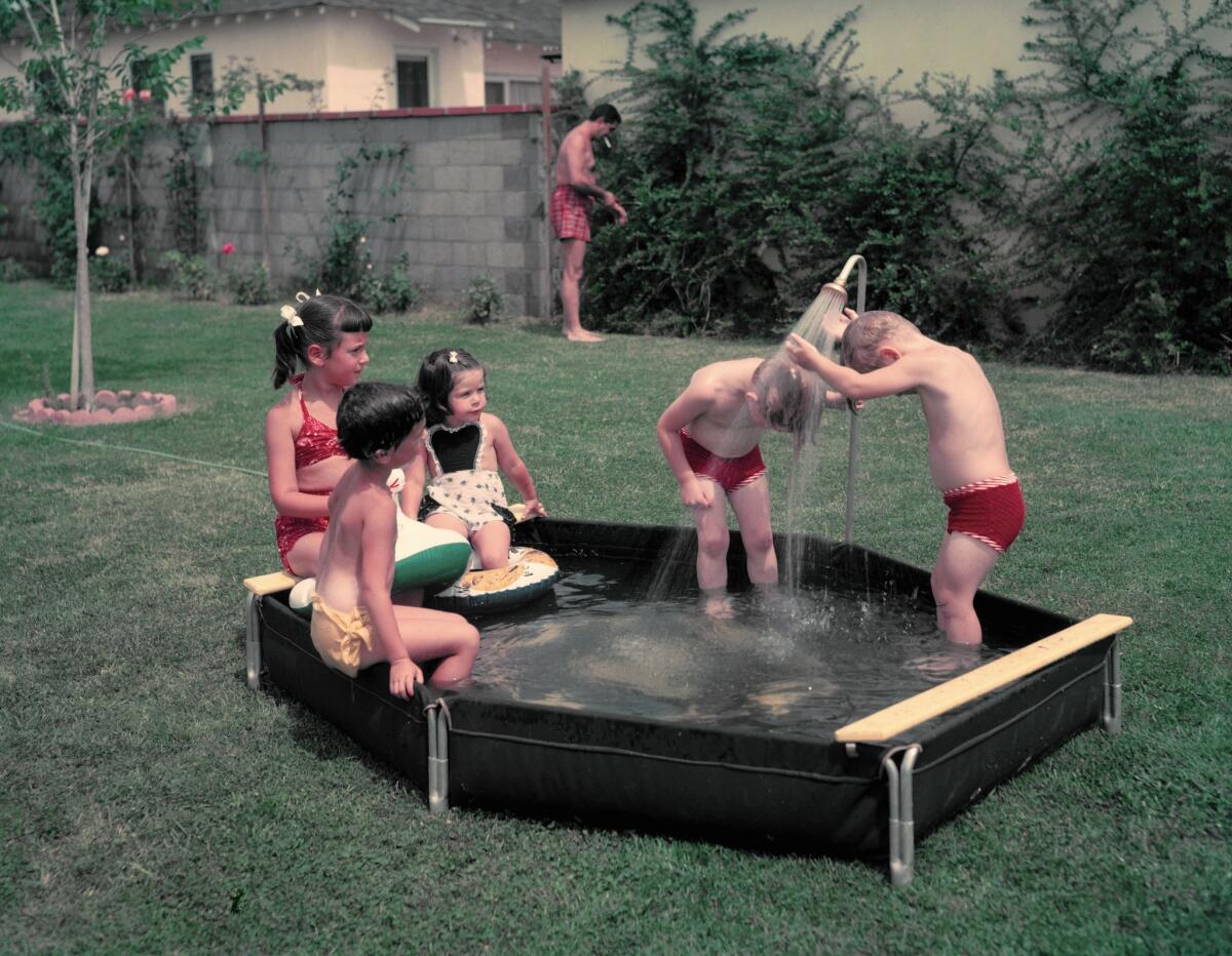 In a classic scene from 1950s suburban California, children play in a wading pool on a big green lawn in Studio City. Are lawns' days numbered in California?