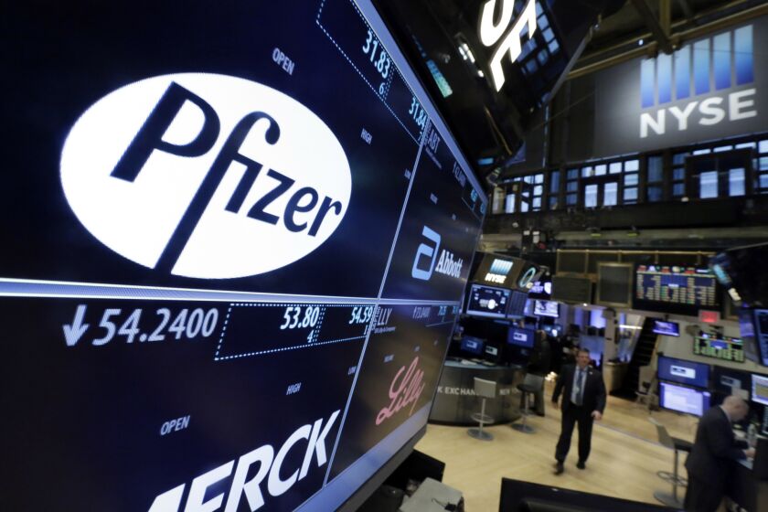 The Pfizer logo appears on a screen on the floor of the New York Stock Exchange.