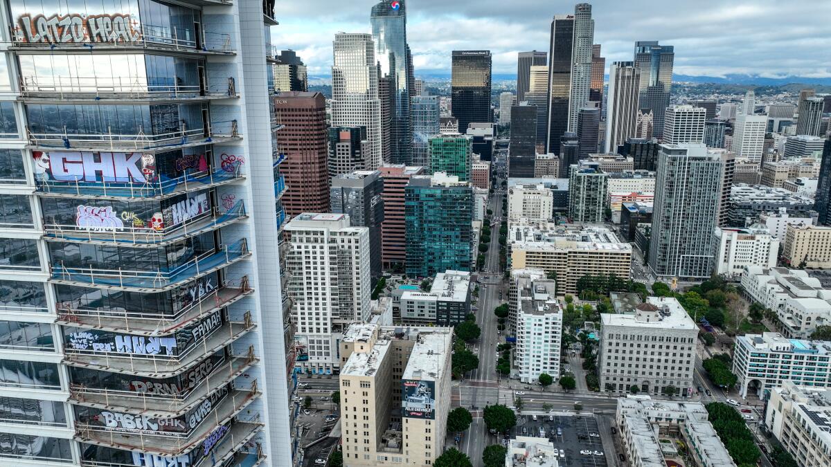 Graffiti on an Oceanwide Plaza building, with the Los Angeles skyline in the background