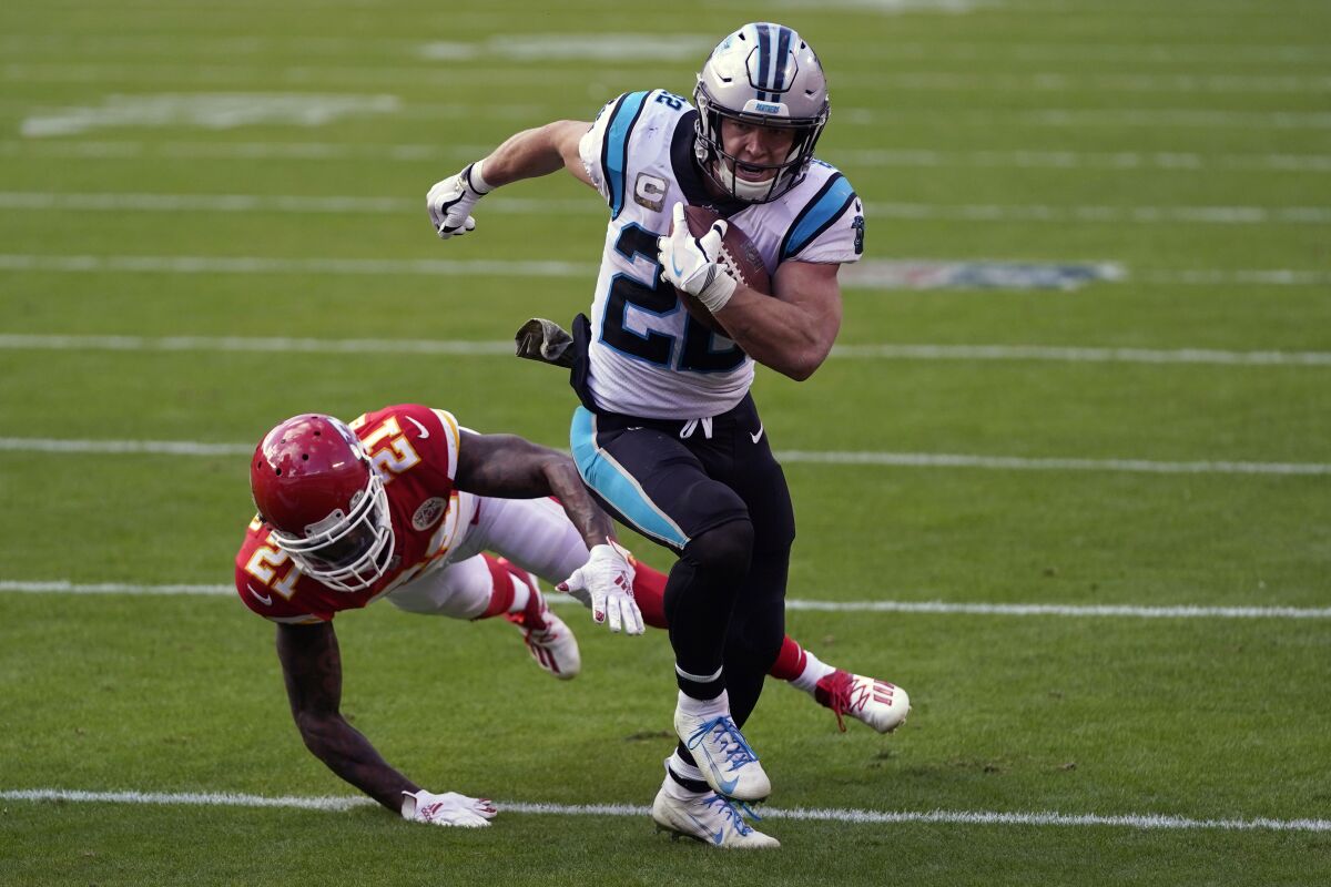 FILE - Carolina Panthers running back Christian McCaffrey (22) runs past Kansas City Chiefs cornerback Bashaud Breeland (21) during the second half of an NFL football game in Kansas City, Mo., in this Sunday, Nov. 8, 2020, file photo. It has been a long, frustrating season for 2019 All-Pro running back Christian McCaffrey. But the Panthers star is ready to return for the final four games of the season after missing nine games this season with ankle and shoulder injuries (AP Photo/Jeff Roberson, File)