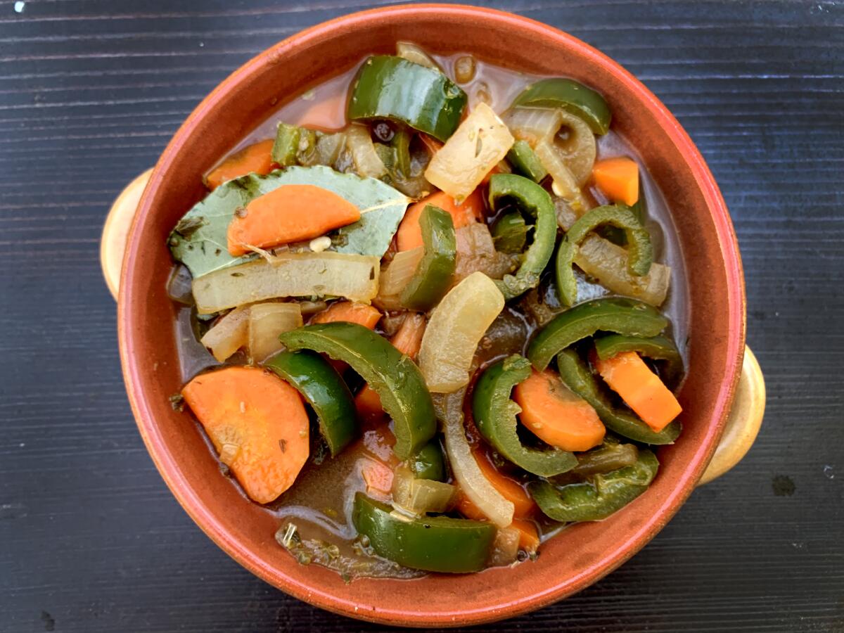 Pickled jalapenos with carrots and onions in a small bowl. 