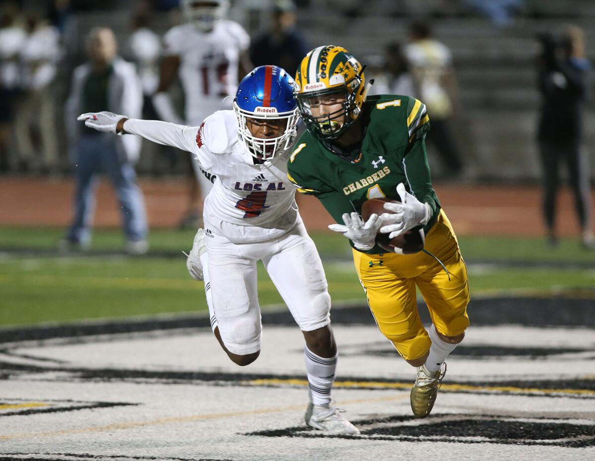 Bradley Luna makes a diving 19-yard touchdown catch to help Edison tie Los Alamitos 14-14 in the second quarter of a Sunset League opener at Huntington Beach High on Friday.