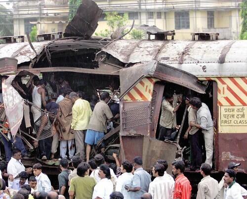 Rescue workers search for bodies inside the mangled compartment of one of the blast affected local trains at Mahim railway station in Mumbai, formerly known as Bombay, on July 11. A series of explosions ripped through commuter trains during evening rush hour in India's financial capital.
