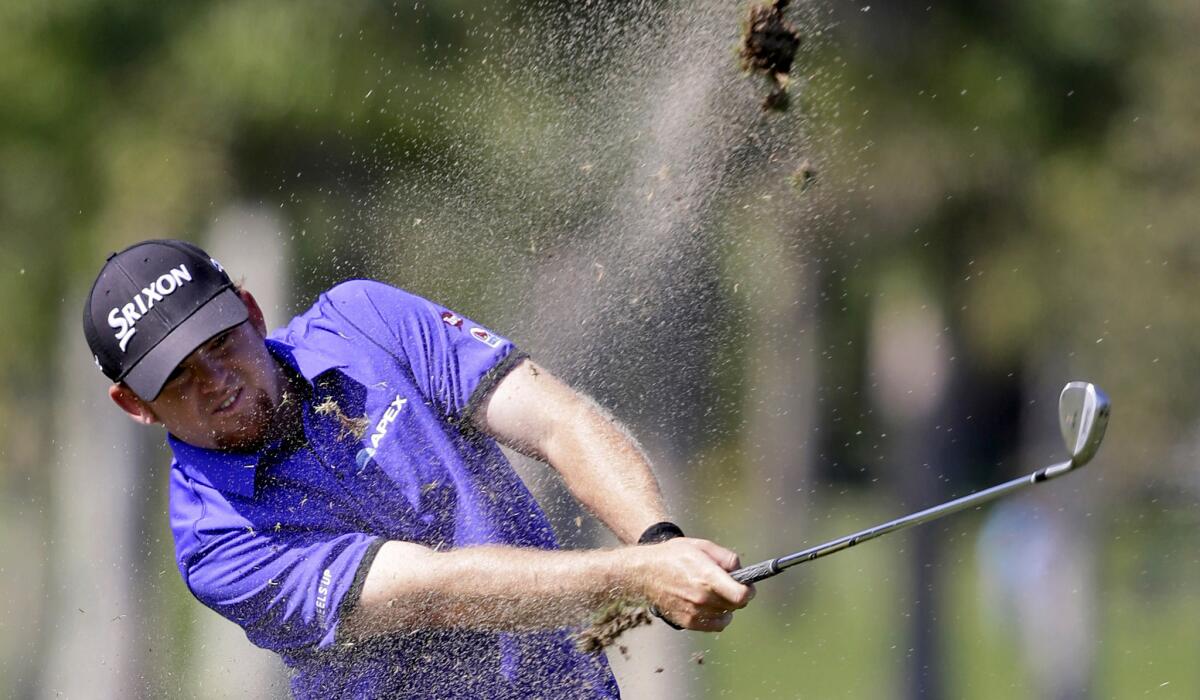 J.B. Holmes hits an approach shot at No. 6 during the second round of the WGC Cadillac Championship on Friday.