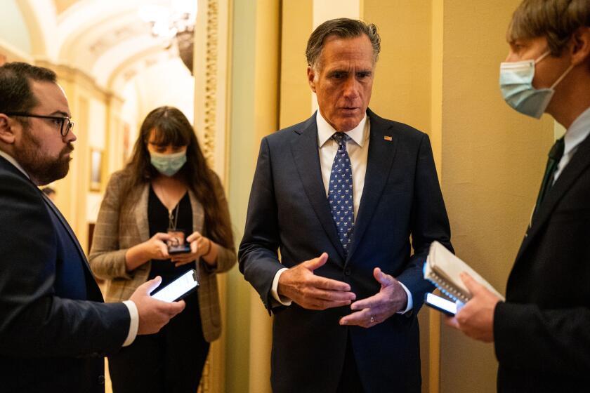 WASHINGTON, DC - DECEMBER 14: Sen. Mitt Romney (R-UT) speaks with a reporter on Capitol Hill on Tuesday, Dec. 14, 2021 in Washington, DC. (Kent Nishimura / Los Angeles Times)