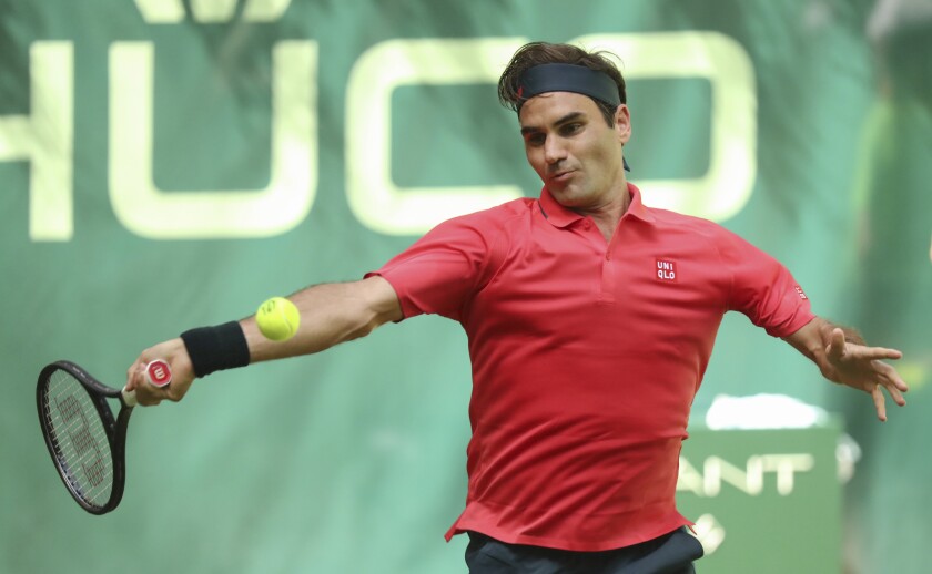 Switzerland's Roger Federer plays the ball during his ATP Tour Singles, Men, 1st Round match against Ilya Ivashka from Belarus in Halle, Germany, Monday, June 14, 2021. (Friso Gentsch/dpa via AP)