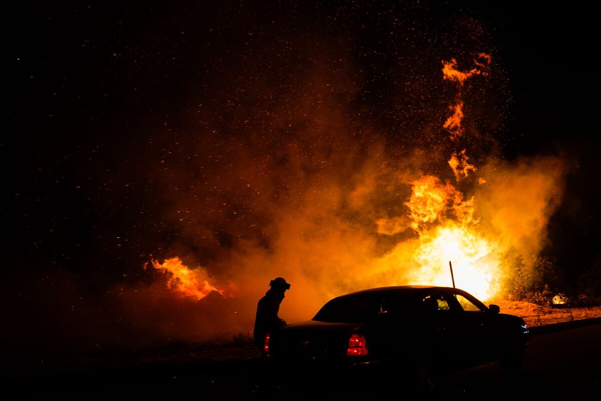 The Creek fire jumps California Highway 168 on Tuesday in Fresno County.