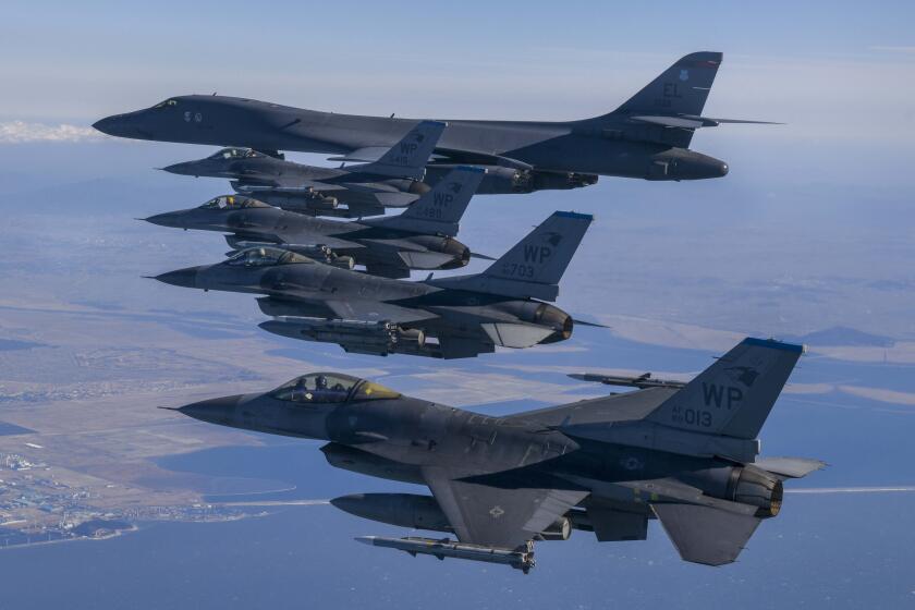 In this photo provided by South Korea Defense Ministry, a U.S. Air Force B-1B bomber, top, flies in formation with U.S. Air Force F-16 fighter jets over the South Korea Peninsula during a joint air drill in South Korea, Sunday, Feb. 19, 2023. (South Korea Defense Ministry via AP)