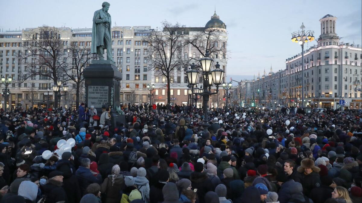 Protesters gather in Moscow following deadly mall fire.