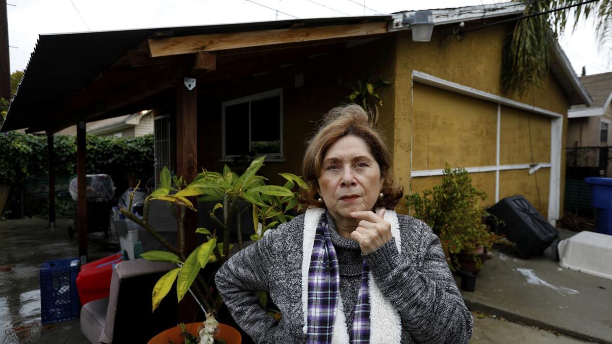 Brisas Zapata, 65, outside her garage at her home in Los Angeles' Jefferson Park neighborhood. Zapata hired a contractor to convert her garage into a two-bedroom unit. But the contractor is now bankrupt and Zapata is on the hook for a loan, though she says no work was done.