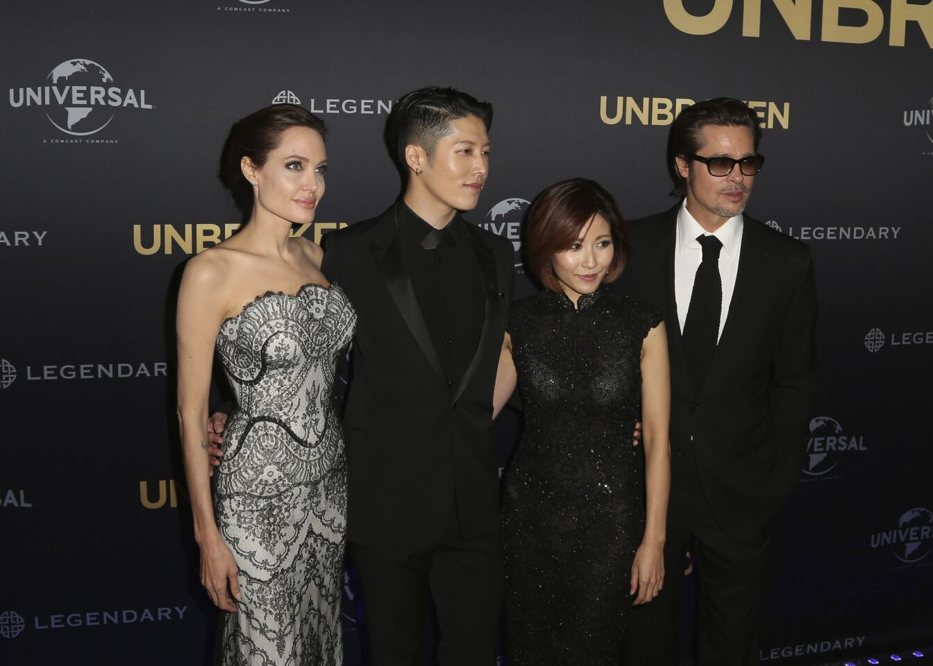 Angelina Jolie, left, director of "Unbroken," poses with Miyavi, second from left, Melody Ishihara and Brad Pitt at the film's world premiere, in Sydney, Australia, on Nov. 17, 2014.