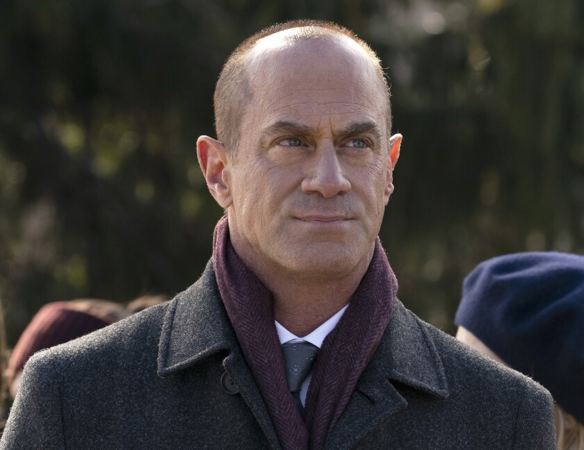 Christopher Meloni in a purple scarf and gray pea coat