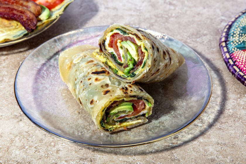 LOS ANGELES, CALIFORNIA, Dec. 11, 2020: A dish from food video-producer and cook Kiano Moju's Christmas menu: a Rolex (Chapati rolled around eggs and veggies) photographed on Friday, Dec. 11, 2020, at Jikoni Studio, a creative culinary space owned by Moju, in Arts District Los Angeles. (Silvia Razgova / For the Times, food and prop styling by Kiano Moju) ATTN: 666808-la-fo-Kiano-Moju-Christmas