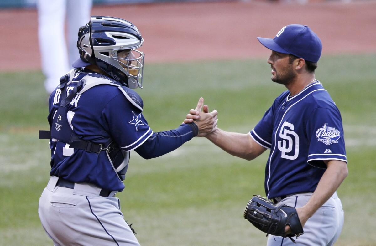 Padres catcher Rene Rivera, left, congratulates closer Huston Street on Wednesday after a 2-1 win over the Cleveland Indians.