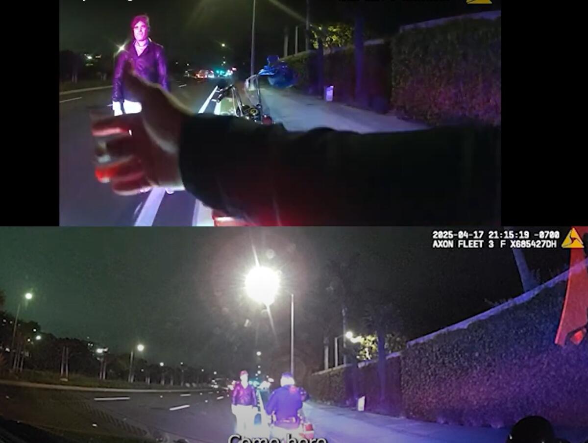 A Newport Beach police officer instructs Geoffrey Stirling to sit down on a curb on April 17.