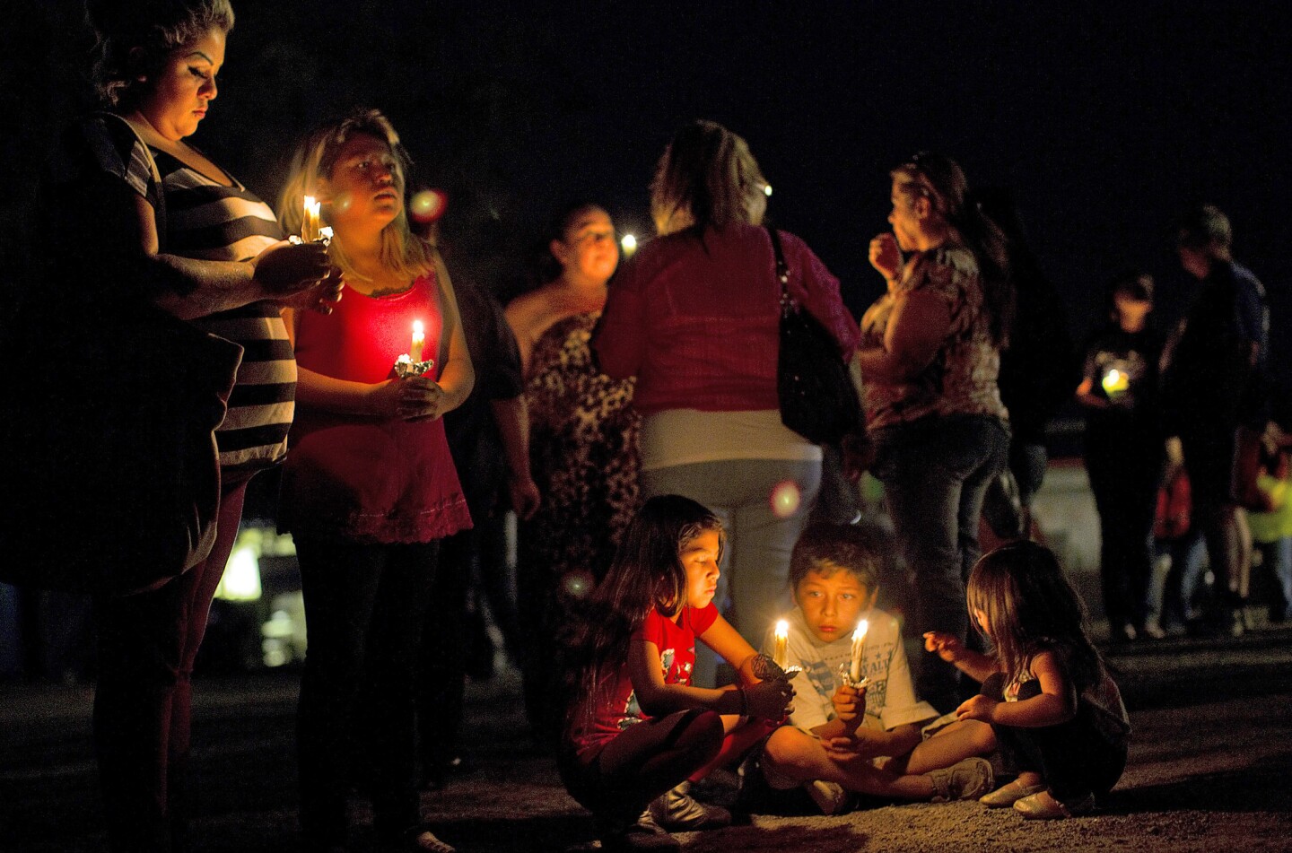Community members hold candles after a vigil for 11-year-old Terry Dewayne Smith, whose body was believed to have been found after an extensive search.