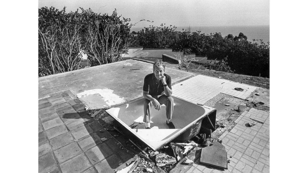 Jan. 30, 1985: Don Dwiggins sits in a bathtub, all that is left of his neighbor's Malibu home.