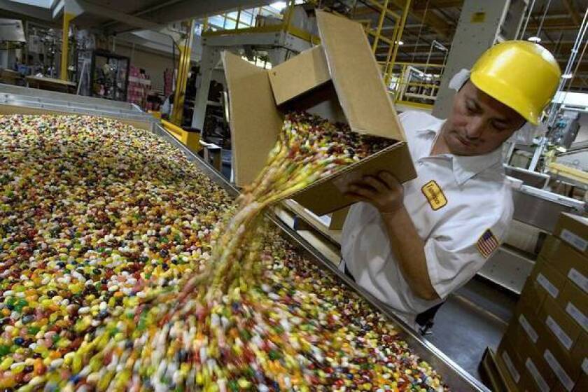 A coalition aimed at ending the U.S. sugar program says it costs consumers as much as $3.5 billion a year in higher food prices. Above, Francisco Tril empties out jelly beans for packaging at the Jelly Belly factory in Fairfield, Calif.