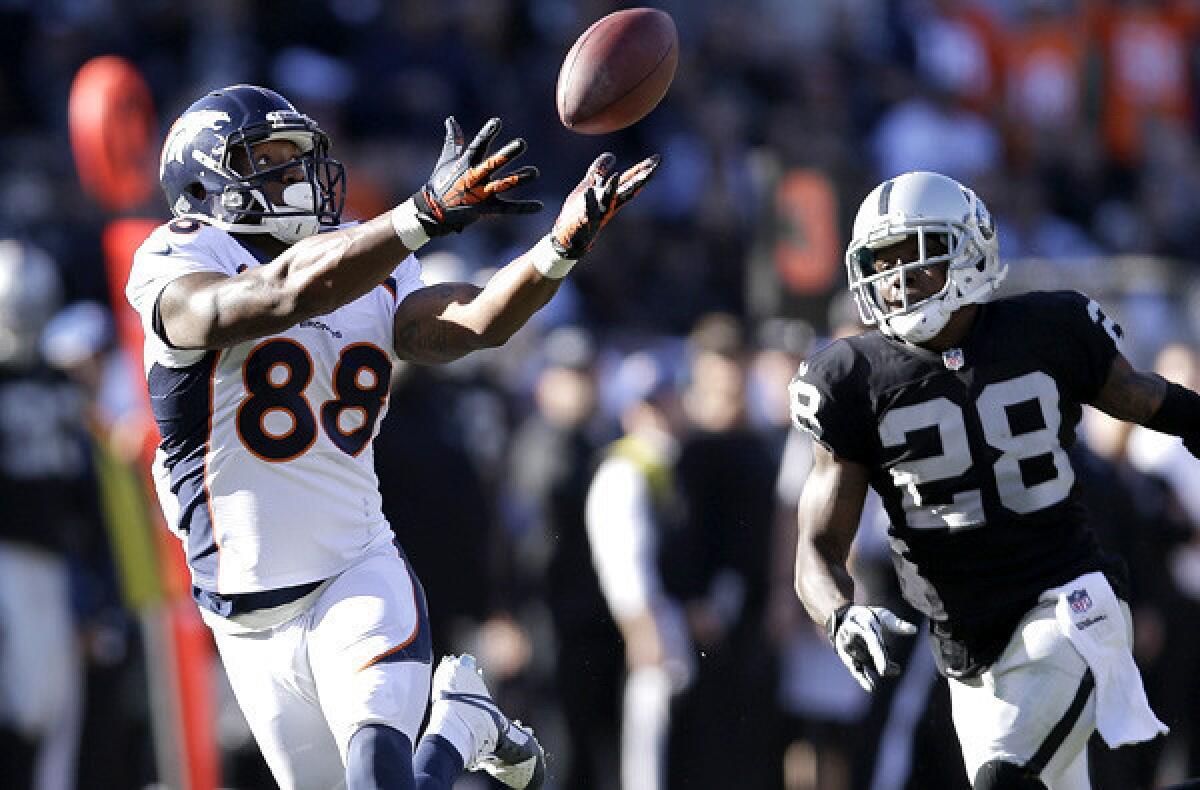 Broncos wide receiver Demaryius Thomas (88) catches a pass against Raiders defensive back Phillip Adams (28) on a 63-yard touchdown play Sunday afternoon in Oakland that helped Denver establish a new record for points in a season.