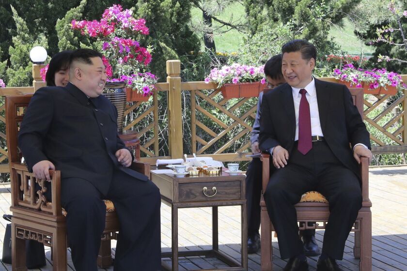 In this photo taken between May 7 and 8, 2018 released by Xinhua News Agency, Chinese President Xi Jinping, right speaks to North Korean leader Kim Jong Un in Dalian in northeastern China's Liaoning Province. (Ju Peng/Xinhua via AP)