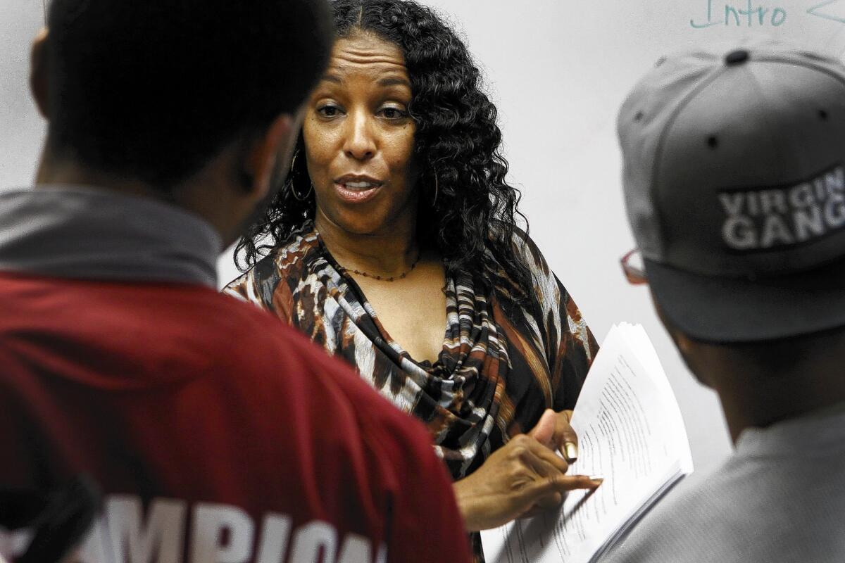 English teacher Sabrena Turner-Odom discusses a homework assignment with students at L.A. Southwest College in this file photo. A report found that black students have been disproportionately affected by budget cuts and a ban on affirmative action.