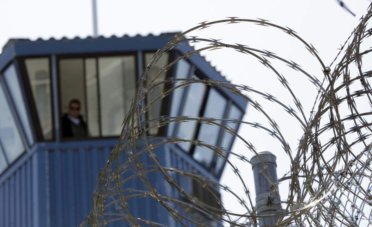 About 1,200 inmates are being held in segregation at Pelican Bay State Prison alone. Above, a guard tower at the prison, seen behind concertina wire.