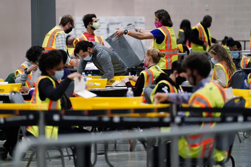 Philadelphia election workers process mail-in and absentee ballots for the general election, at the Pennsylvania Convention Center, Tuesday, Nov. 3, 2020, in Philadelphia. (AP Photo/Matt Slocum)