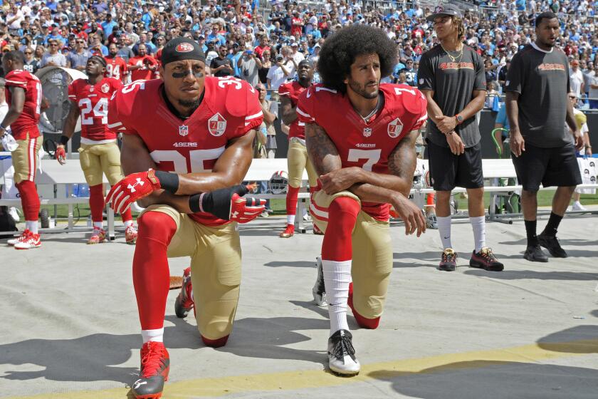 FILE - In this Sept. 18, 2016, file photo, San Francisco 49ers' Colin Kaepernick (7) and Eric Reid (35) kneel during the national anthem before an NFL football game against the Carolina Panthers, in Charlotte, N.C. Colin Kaepernick and Eric Reid have reached settlements on their collusion lawsuits against the NFL, the league said Friday, Feb. 19, 2019. (AP Photo/Mike McCarn, File)