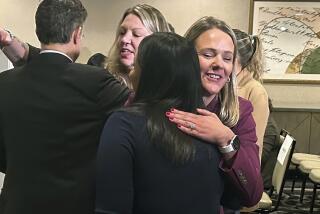 Attorney Kelly Fitzpatrick, right, hugs plaintiff Soryorelis Henry, foreground right, after a news conference in New Haven, CT, Monday, Sept. 9, 2024, where dozens of women who say they suffered excruciating pain at a Yale University fertility clinic because a nurse stole fentanyl for her own use and replaced it with saline, have settled their lawsuits against the Ivy League school. (AP Photo/Dave Collins)