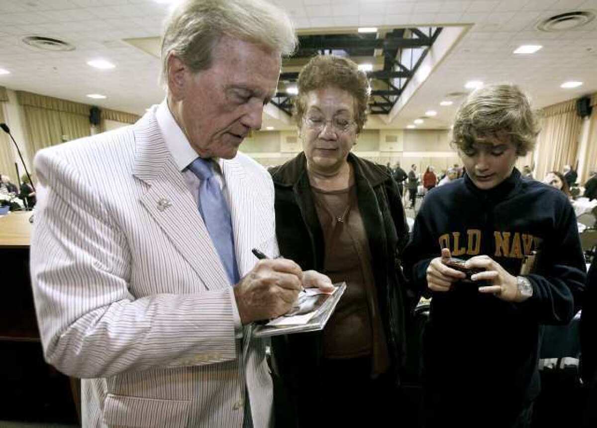 Singer, actor, writer Pat Boone signed autographs after giving the keynote address at the 50th Annual Glendale Mayor's Prayer Breakfast at the Glendale Civic Auditorium in Glendale on Thursday, March 21, 2013.