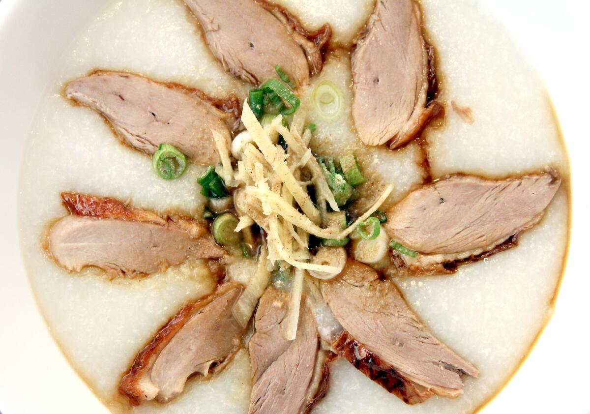 Sliced roasted duck porridge with scallions, ginger, pepper and a hint of soy sauce from Siam Sunset restaurant.