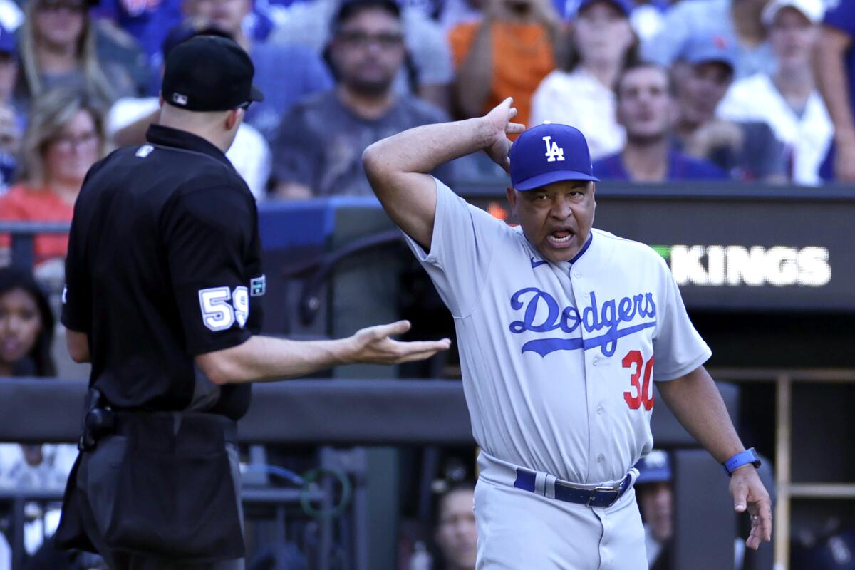 Dodgers manager Dave Roberts yells at home plate umpire Nic Lentz.