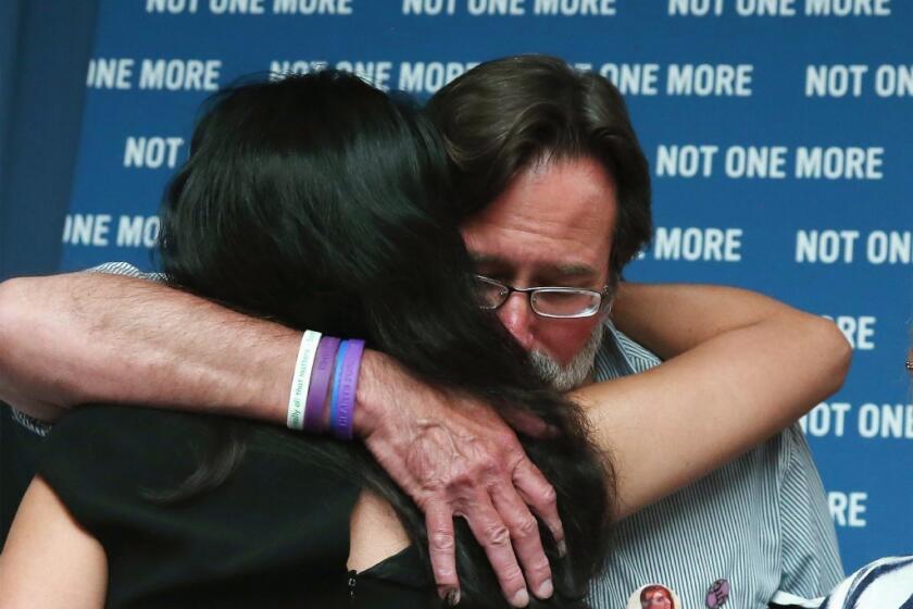Roxanna Green, mother of Christina Taylor Green, who was shot and killed during a shooting rampage in Tucson, receives a hug from Richard Martinez, whose son Christopher Michaels-Martinez was recently shot and killed during a shooting near UC San Barbara.