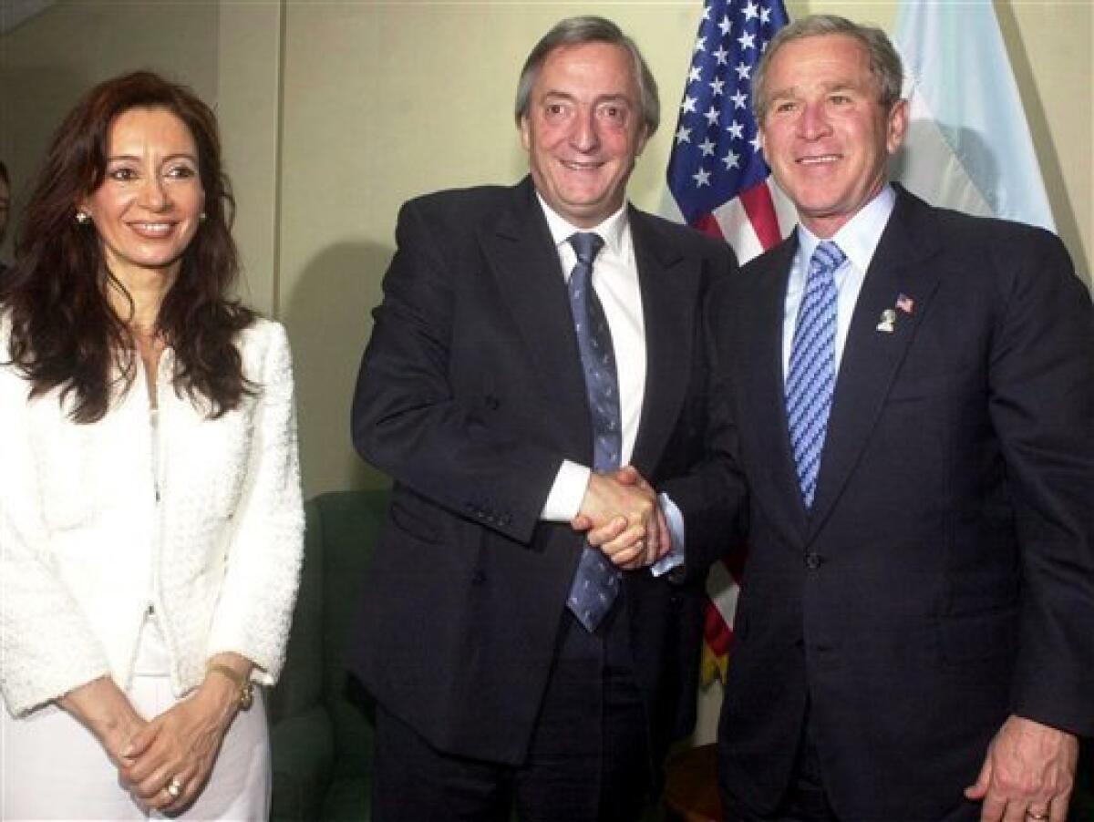 In this Jan. 13, 2004 file photo released by Argentina's Presidential Press Office, President George W. Bush, right, shakes hands with Argentina's President Nestor Kirchner, center, as Argentine first lady Cristina Fernandez looks on at the Special Summit of the Americas in Monterrey, Mexico. According to state television in Argentina, Nestor Kirchner died on Wednesday Oct. 27, 2010 of a heart attack at age 60. (AP Photo/Argentina Presidential Press Office, File)
