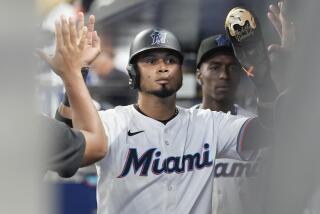 Miami Marlins' Luis Arraez is congratulated by his teammates after he scored on a a single by Jazz Chisholm Jr., during the first inning of a baseball game against the Colorado Rockies, Thursday, May 2, 2024, in Miami. (AP Photo/Marta Lavandier)