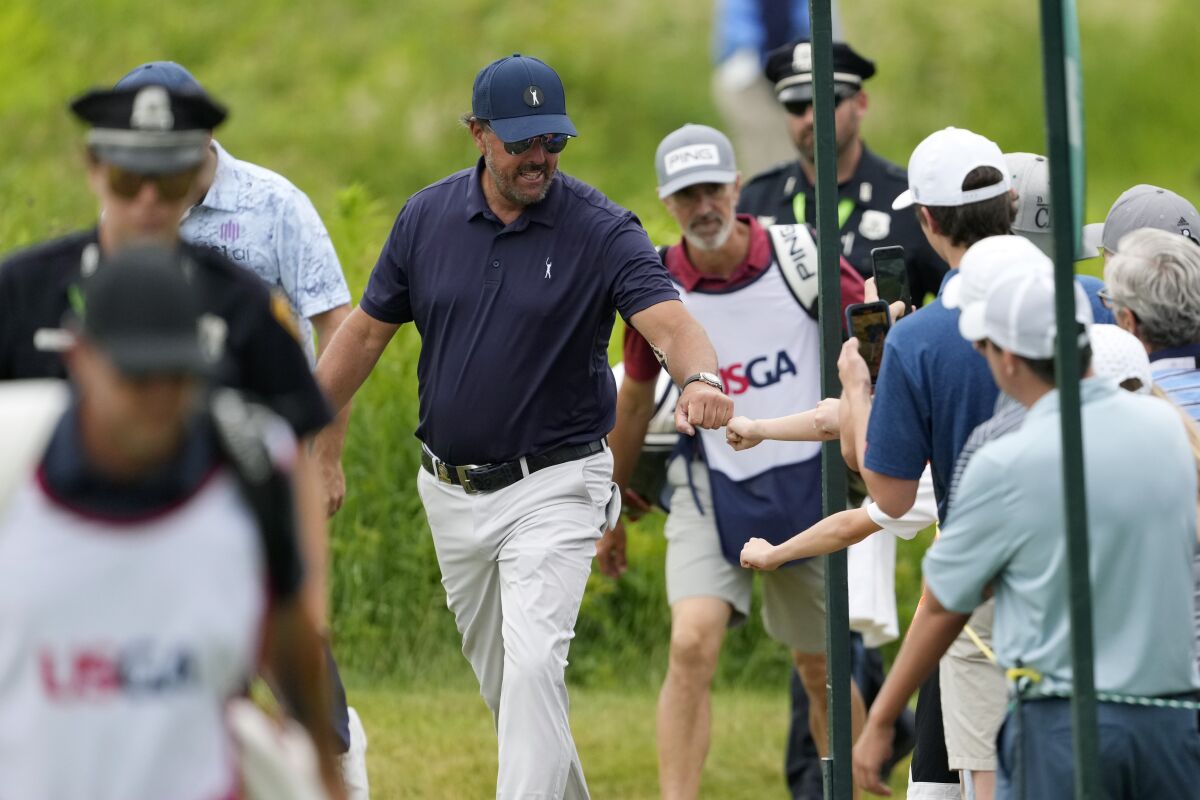 Phil Mickelson greets fans during the second round of the U.S. Open golf tournament at The Country Club, Friday, June 17, 2022, in Brookline, Mass. (AP Photo/Robert F. Bukaty)