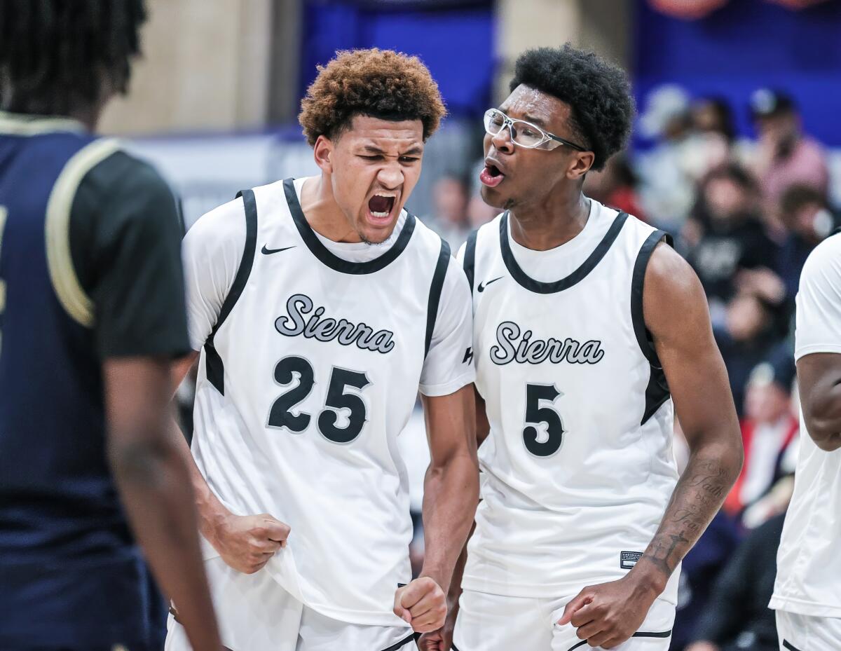Maximo Adams, left, gets fired up after a basket and receives encouragement from Sierra Canyon teammate Bryce James.
