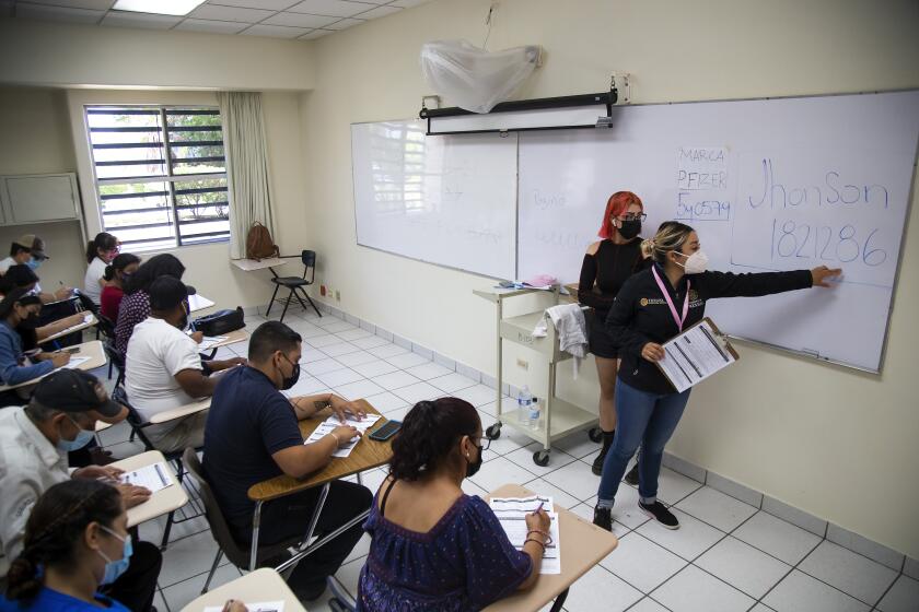 TIJUANA, MEXICO - JUNE 17: Citizens who have received the U.S. donated Johnson & Johnson vaccine against Covid-19 are helped by health workers to fill up a document with personal information at Universidad de Baja California on June 17, 2021 in Tijuana, Baja California. After the visit of Vice president Harris to Mexico, US sent a donation of 1.35 million doses of Johnson and Johnson vaccine. Vaccines will be administrated to anyone over 18 in 39 towns from the Mexican side of the border with United States. The aim of the project is to boost vaccination rates to level of the American cities across the border. (Photo by Francisco Vega/Getty Images)