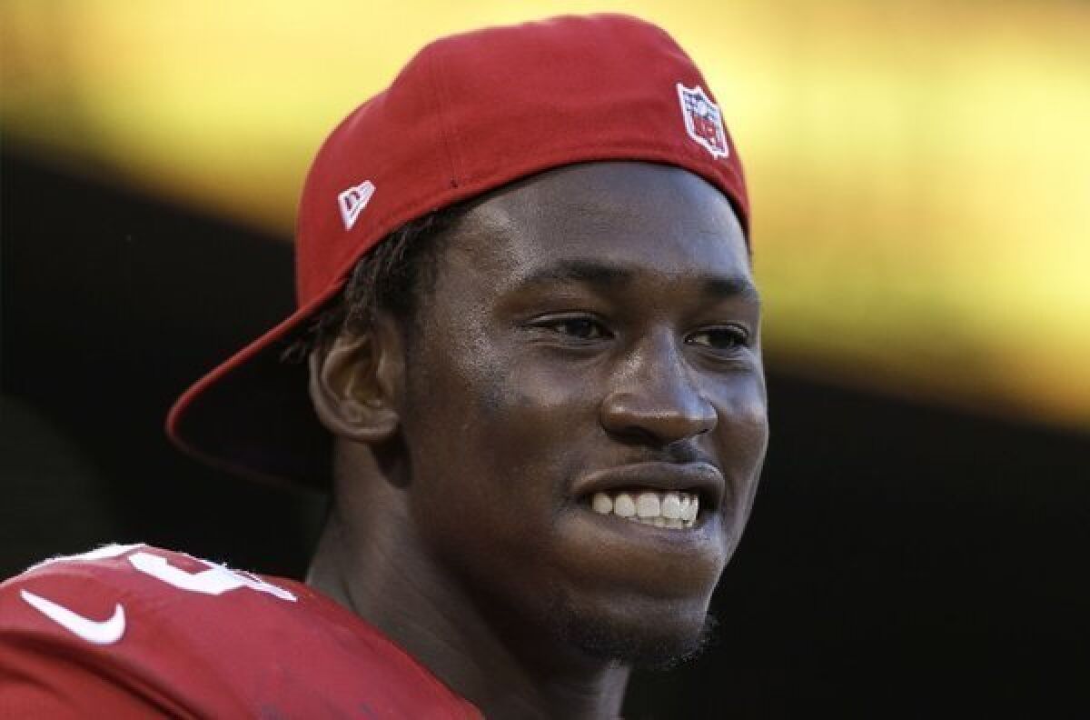 San Francisco 49ers linebacker Aldon Smith stands on the sideline during an NFL preseason game.