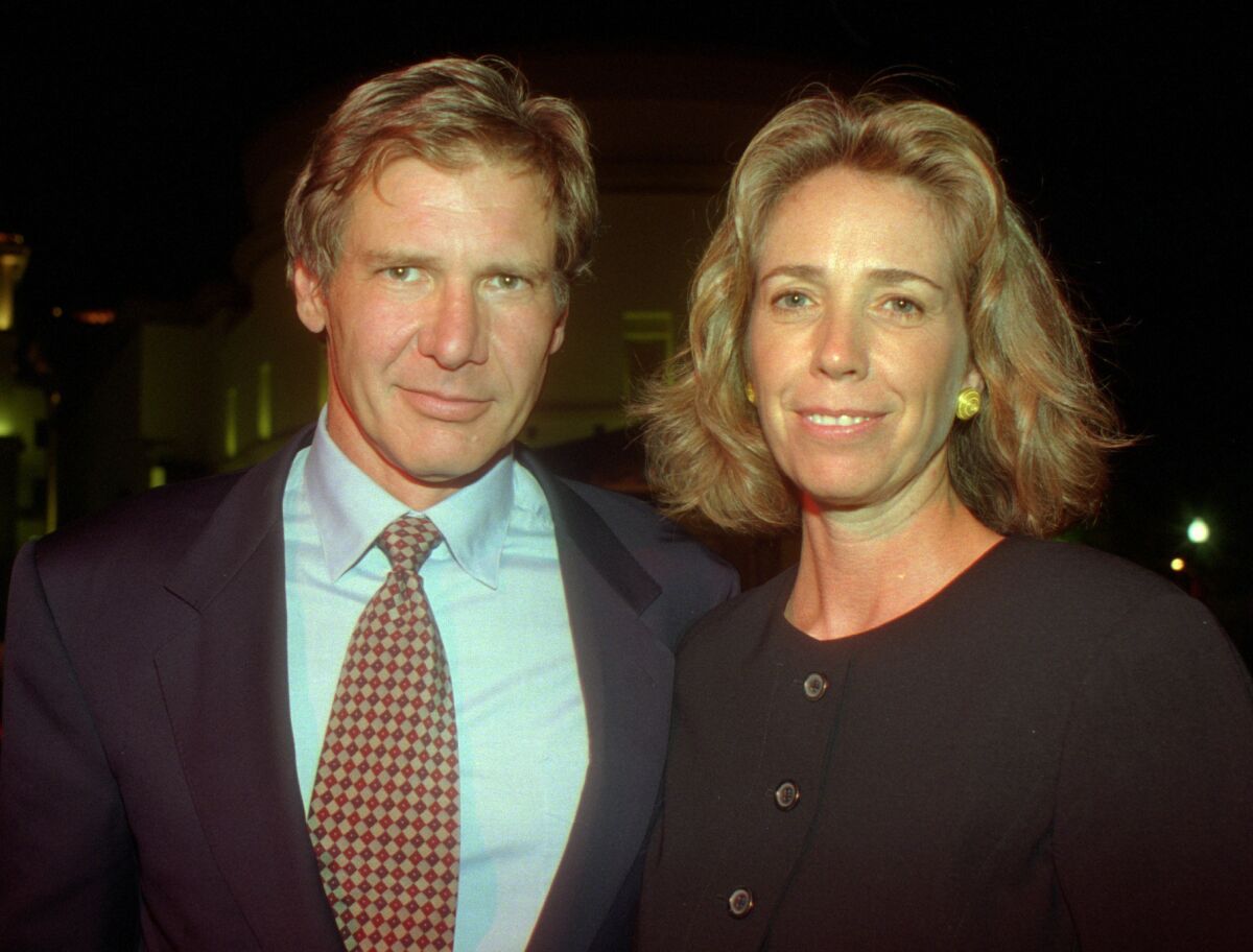 Melissa Mathison and then-husband Harrison Ford attend the premiere party for "Clear and Present Danger" on the grounds of Paramount Pictures on Aug. 3, 1994.