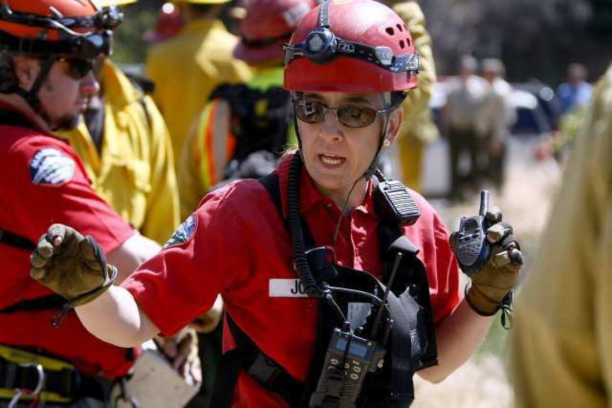 Altadena Mountain Rescue Team member Alexia Joens directs the rope handlers as they bring up a "victim" during multi-agency "over-the-side" high angle, technical rescue exercise on Angeles Crest Highway on Friday, April 26, 2013. About 100 personnel from different local agencies participated, including the Los Angeles County Sheriff's Montrose Search & Rescue Team, Altadena SAR, L.A. County firefighters from La Canada Flintridge and Pico Rivera along with Air Rescue 5, and the U.S. Forest Service.