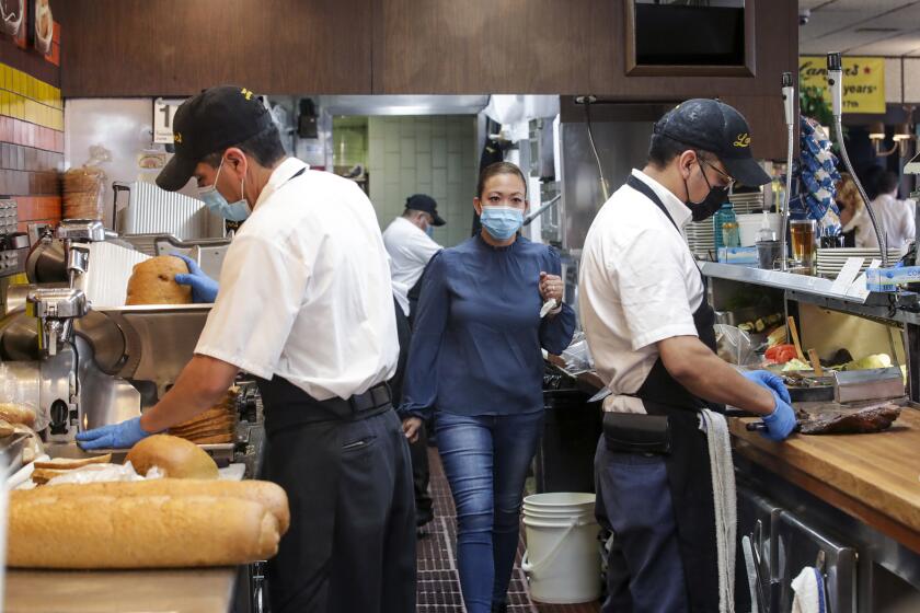 Los Angeles, CA - June 15: Cooks and food preparers busy at the re-opening for the first time in over a year for in-person dining at Langer's Delicatessen-Restaurant on Tuesday, June 15, 2021 in Los Angeles, CA. (Irfan Khan / Los Angeles Times)