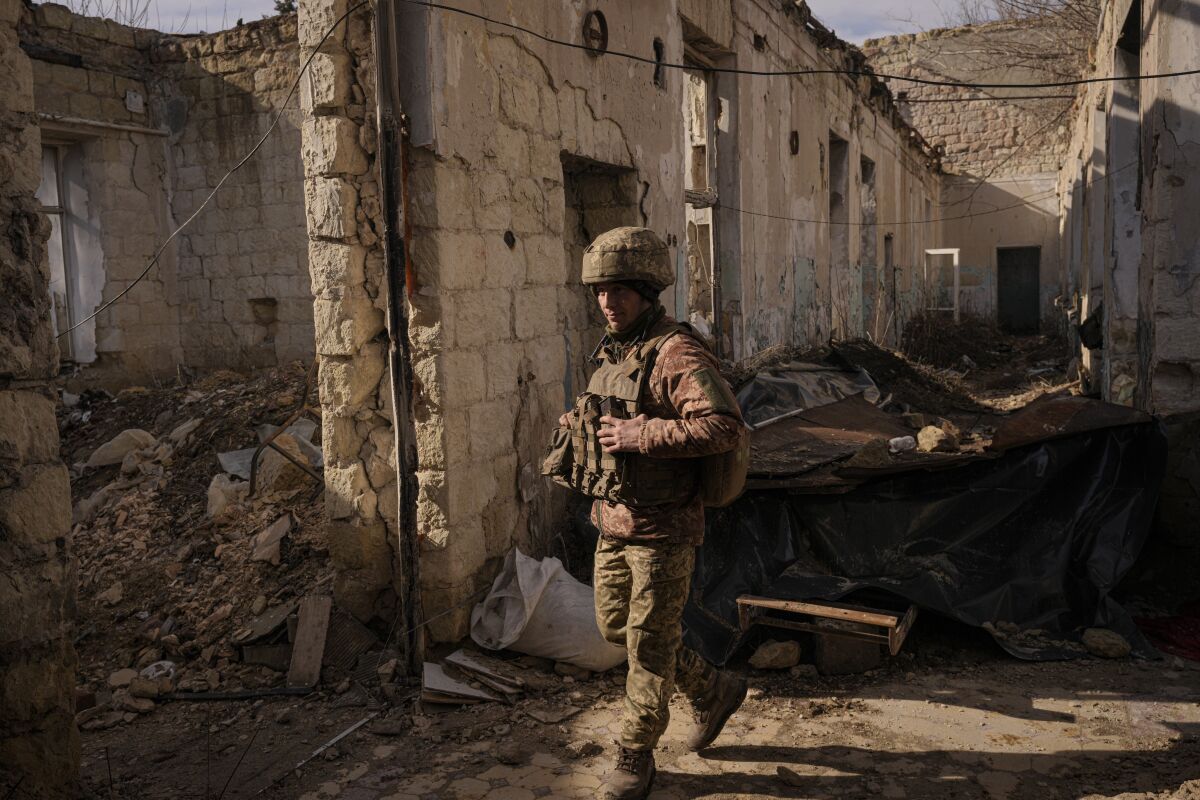 Ukrainian soldier inside a destroyed house